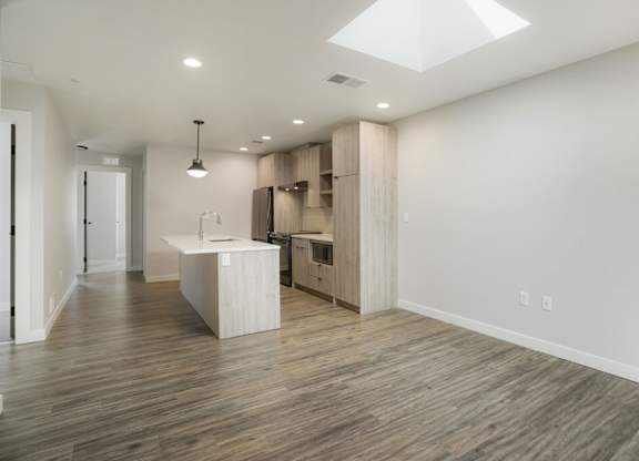 A spacious kitchen with wooden floors and a skylight at The Avenue Lofts Golden Apartments, Golden