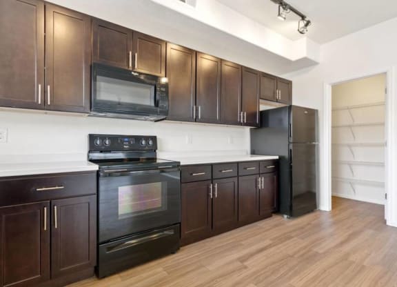 Fully Equipped Kitchen Includes Frost-Free Refrigerator, Electric Range, & Dishwasher at Belle Creek Commons, Henderson, CO