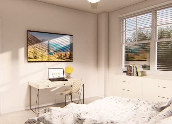 Spacious bedroom with a desk and laptop at Brownstones at Palisade Park, Broomfield