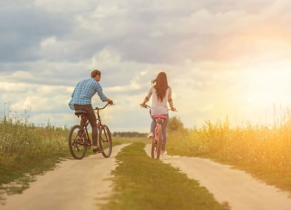 a man and a woman riding bikes at Brownstones at Palisade Park, Broomfield, CO,  80023