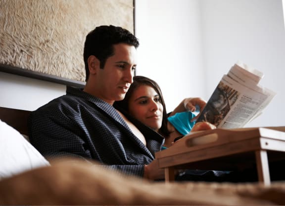 Reading On Couch at Belle Creek Commons, Henderson, CO, 80640