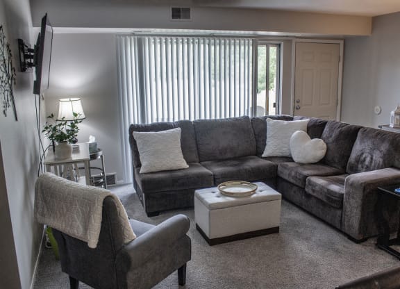 a living room with a couch and two chairs