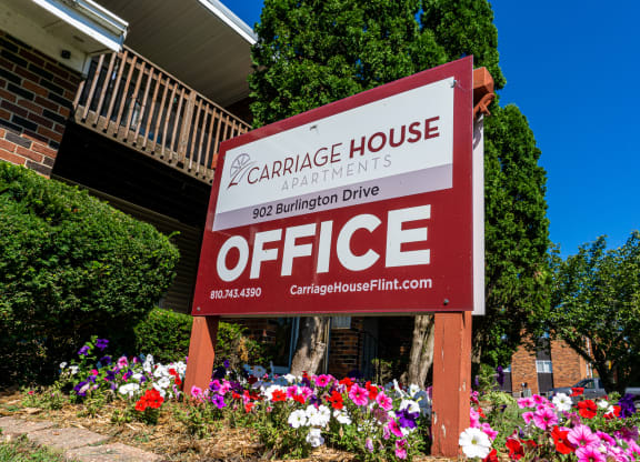 Office sign and landscaping at Carriage House Apartments in Flint, Michigan
