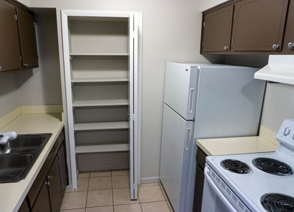 Fully equipped kitchen with ample closet space at Carriage House Apartments in Flint, Michigan