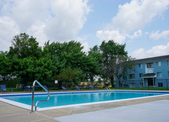 Resort Style Swimming Pool with pool chairs and easy entry, at Gale Gardens Apartments
