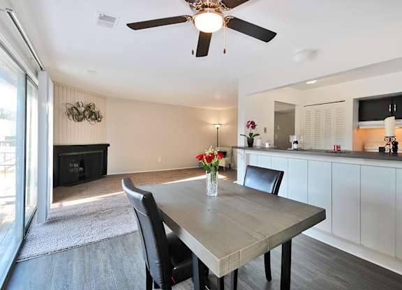 Open-concept living and dining area at Woodcrest Apartments in Westland, Michigan showcasing flexible floor space and contemporary design.