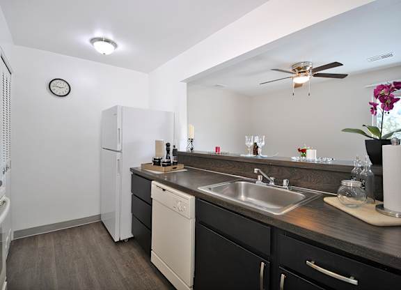 Spacious Kitchen Woodcrest Apartments in Westland, Michigan with stainless steel appliances, white cabinetry, and ample counter space.