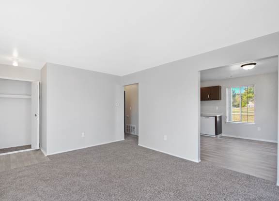Open-concept living room with dining area and kitchen at Farmbrooke Manor Clinton Township MI