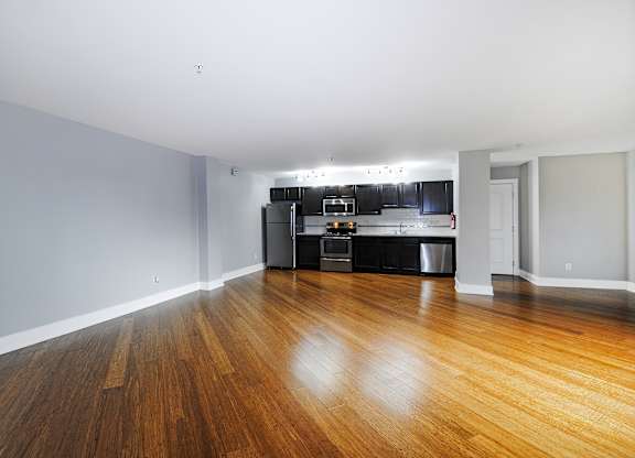 A kitchen with a wooden floor and spacious living room in Kalamazoo, MI