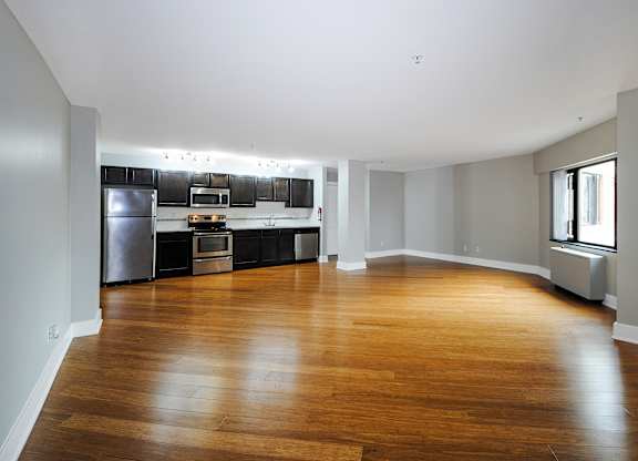 A spacious kitchen with wooden floors and modern appliances in Kalamazoo, MI