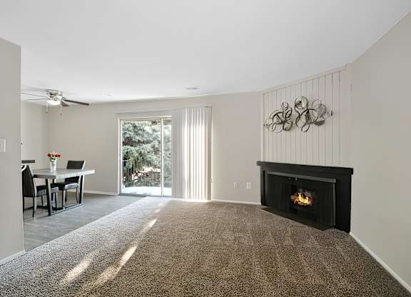 Open-concept living and dining area at Woodcrest Apartments in Westland, Michigan showcasing flexible floor space and contemporary design.