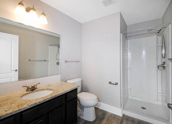A bathroom with a sink, toilet, and shower in Kalamazoo, MI