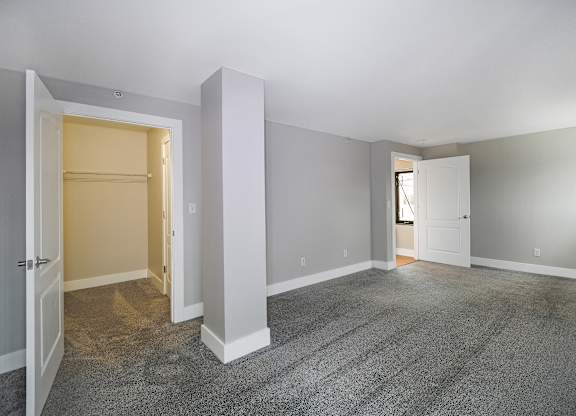 A room with a carpeted floor and white walls.