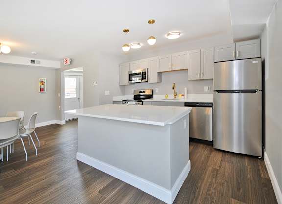 Resident clubhouse with fully equipped stainless steel appliances kitchen Warren Woods Apartments in Warren, MI.