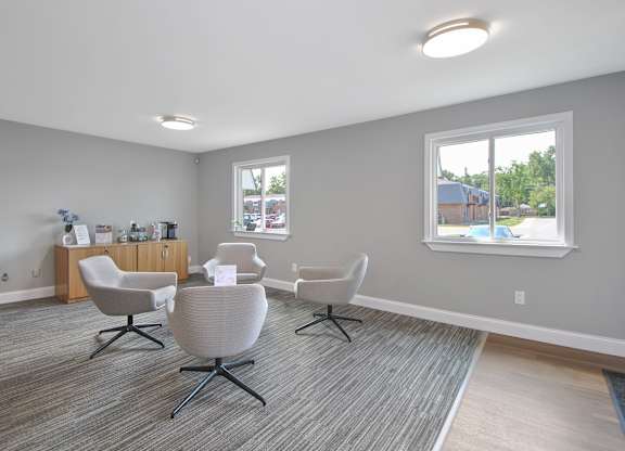 Leasing office lounge with contemporary seating area and welcoming reception at Warren Woods Apartments in Warren, MI.
