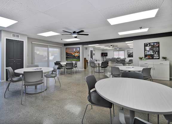 A conference room with a white table and chairs.