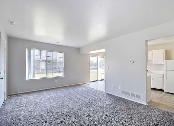 Open-concept living room with dining area and kitchen at Farmbrooke Manor Clinton Township MI