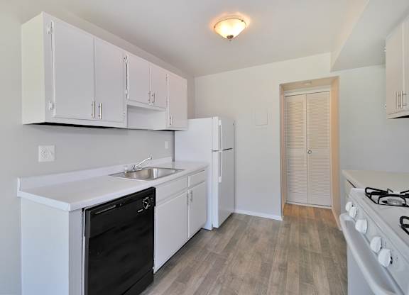 “Fully equipped apartment kitchen with modern appliances at Farmbrooke Manor Clinton Township MI