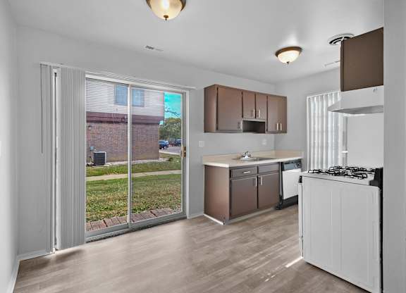 Fully equipped apartment kitchen with modern appliances at Farmbrooke Manor Clinton Township MI