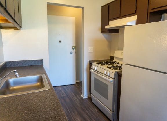 Fully equipped kitchen at Golf Manor Apartments in Roseville, Michigan