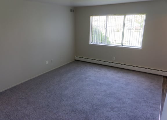 Spacious living room at Golf Manor Apartments in Roseville, Michigan