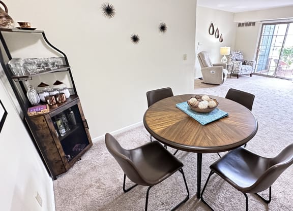 a dining room with a table and chairs and a living room