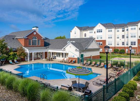 a large swimming pool with a building in the background