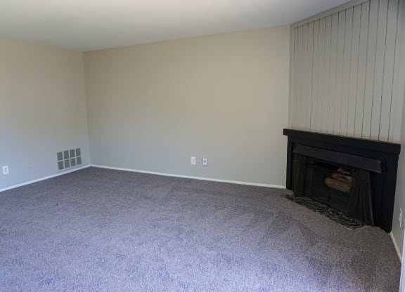 Fireplace and spacious living room at Woodcrest Apartments in Westland, Michigan