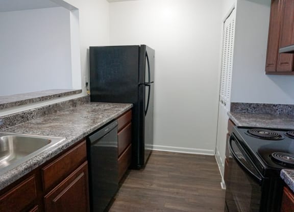 Fully Equipped Kitchen with granite counter tops at Woodcrest Apartments in Westland, Michigan