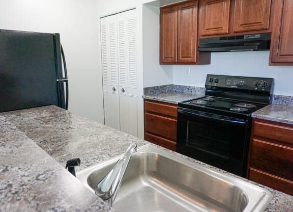 Fully Equipped Kitchen with granite counter tops at Woodcrest Apartments in Westland, Michigan