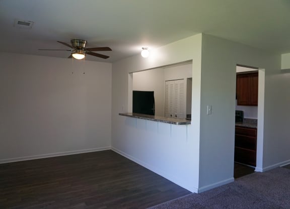 Spacious dining room and kitchen with granite countertop at Woodcrest Apartments in Westland, Michigan