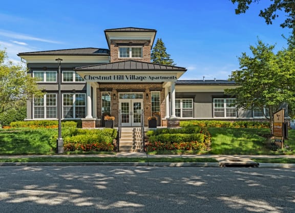 a large building with a sign on the front of it that says chesterfield hill village  at Chestnut Hill Village, Philadelphia, PA