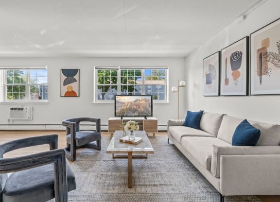 a living room with a couch chairs and a coffee table  at Chestnut Hill Village, Pennsylvania