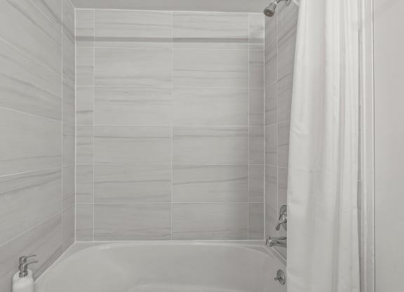 a bathroom with a bathtub and a shower curtain  at Chestnut Hill Village, Philadelphia, PA