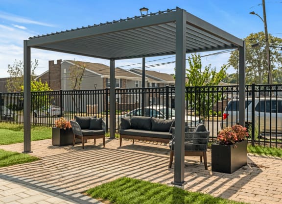 a pergola with two couches on a brick patio  at Chestnut Hill Village, Pennsylvania