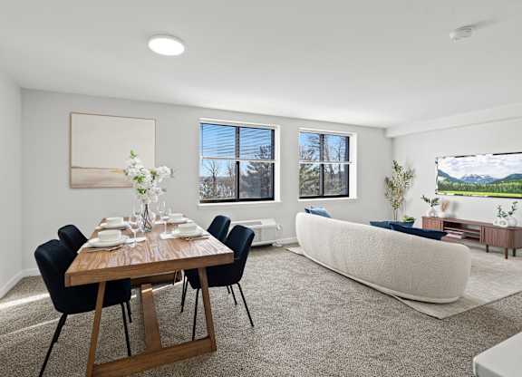 A dining room with a wooden table and chairs.