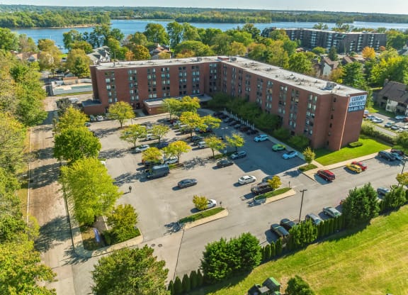 an aerial view of a parking lot in front of a building