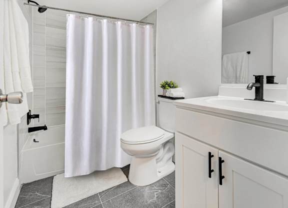 Renovated bathroom with tub and shower at Chestnut Hill Village Apartments, Philadelphia, PA