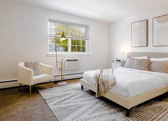 Bright bedroom with queen bed and window at Chestnut Hill Village Apartments, Philadelphia, PA