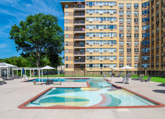 a swimming pool with an apartment building in the background at Parkview Towers, New Jersey, 08107