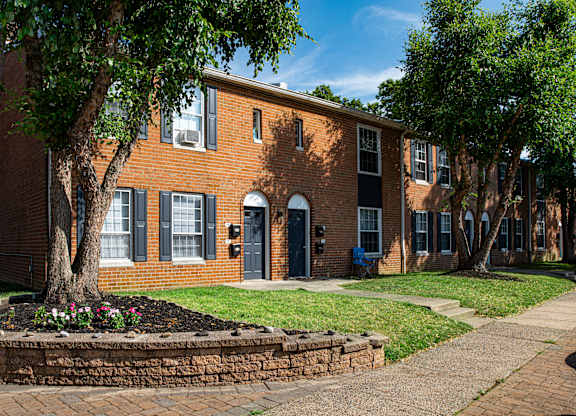 a large brick building with a tree in front of it