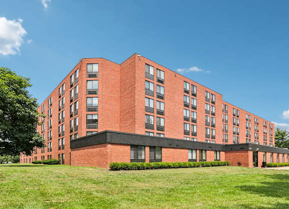A red brick building with a black base and windows on the side.