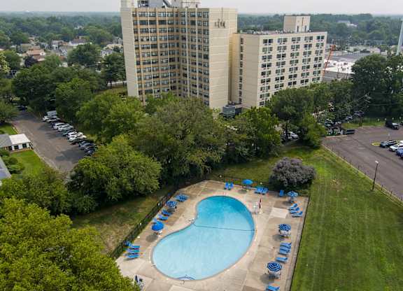 A large swimming pool surrounded by lawn chairs at Premier at Cherry Hill, Cherry Hill, NJ 08002