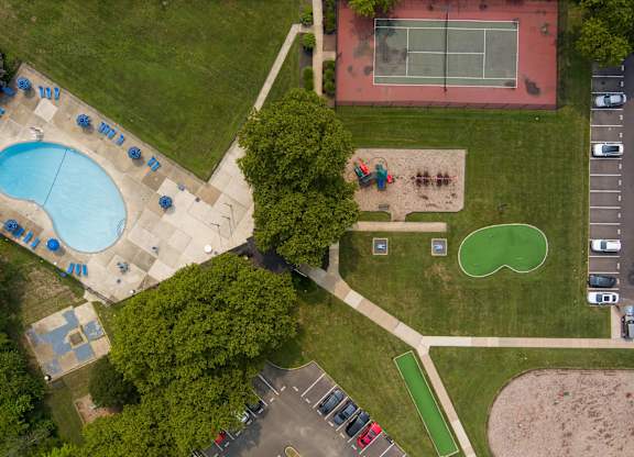 A park with a tennis court, a basketball court, a swimming pool, and a playground at Premier at Cherry Hill, Cherry Hill, NJ