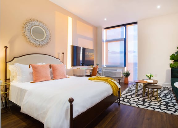 a bedroom with a bed and a large window