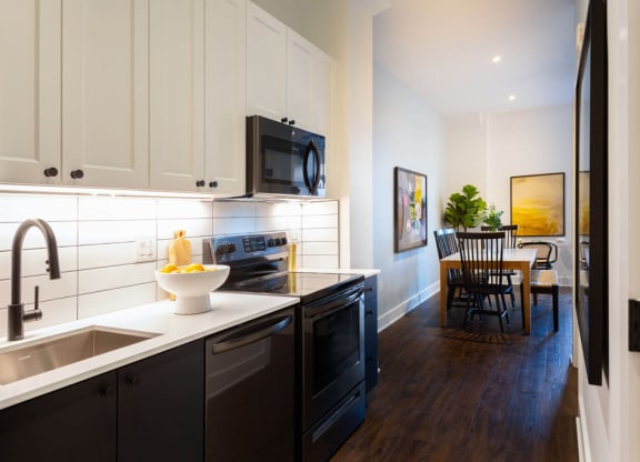 a kitchen and dining room with a sink and a microwave at The Irvine, Philadelphia, Pennsylvania