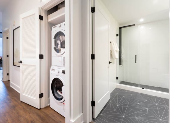 a bathroom with a washer and dryer in a closet at The Irvine, Philadelphia
