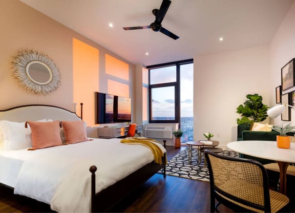 a bedroom with a bed and a table and a living room at The Irvine, Philadelphia, Pennsylvania