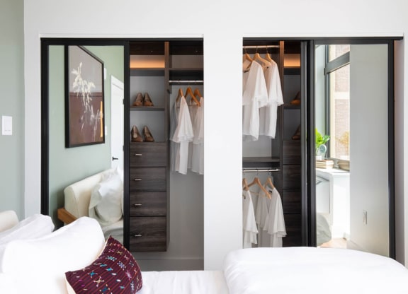 a bedroom with a closet full of clothes and a bed at The Irvine, Philadelphia, Pennsylvania