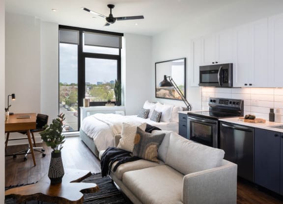 a living room with a couch and a kitchen at The Irvine, Philadelphia